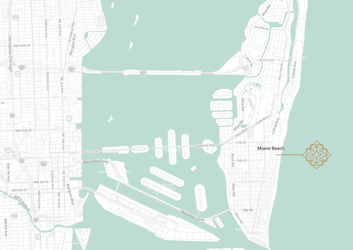 A map showing a coastal area with a marina, docks, and a bridge connecting a mainland to a barrier island; light teal water and pale streets, labeled &ldquo;Manal Beach&rdquo; and nearby harbor facilities.